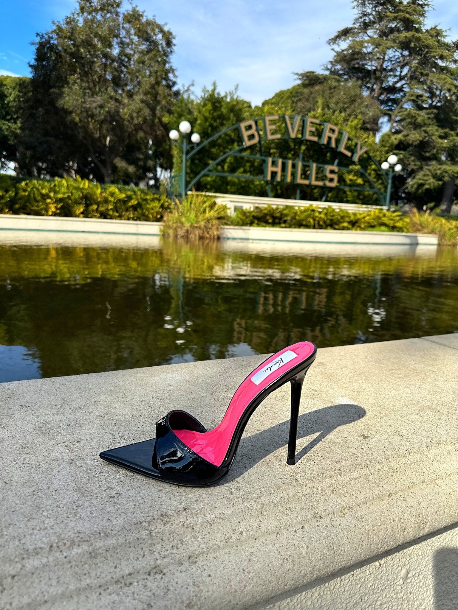 Side view of pink patent mules with quilted texture and knife-point toe