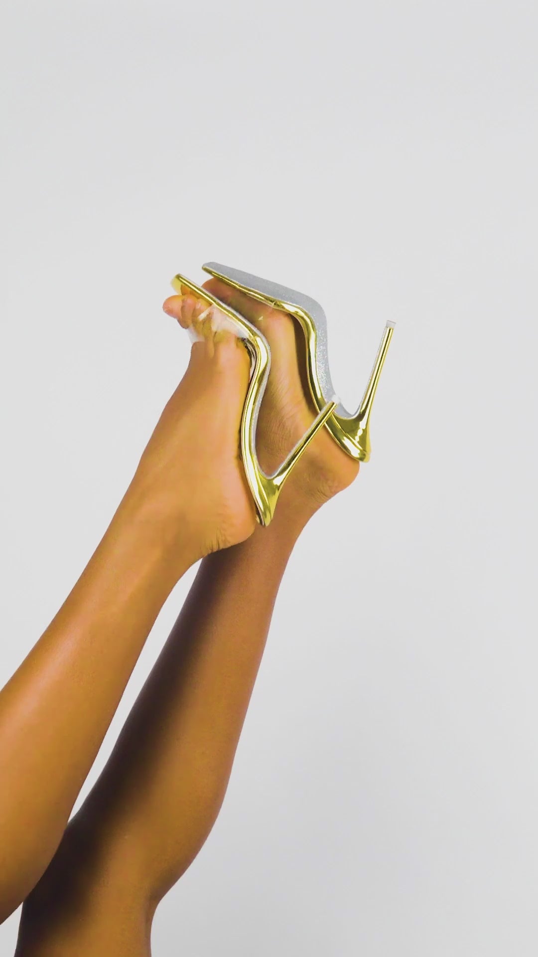 Glossy Golden Hour mules with radiant glitter finish and clear vinyl strap
