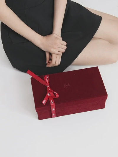 Top view of red mirror mules with sleek straps and glossy surface