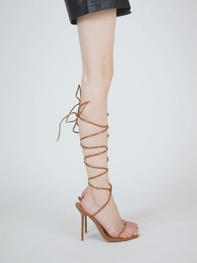 High-shine tan patent sandals in vegan leather with modern design